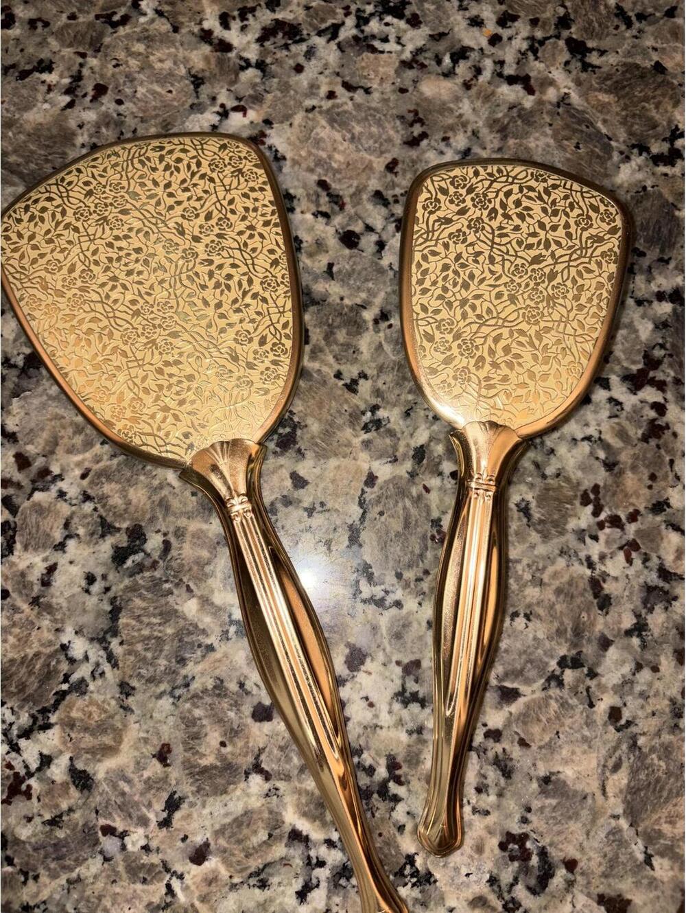 This is a mid-20th century Aljen gold-tone vanity hairbrush and mirror set.